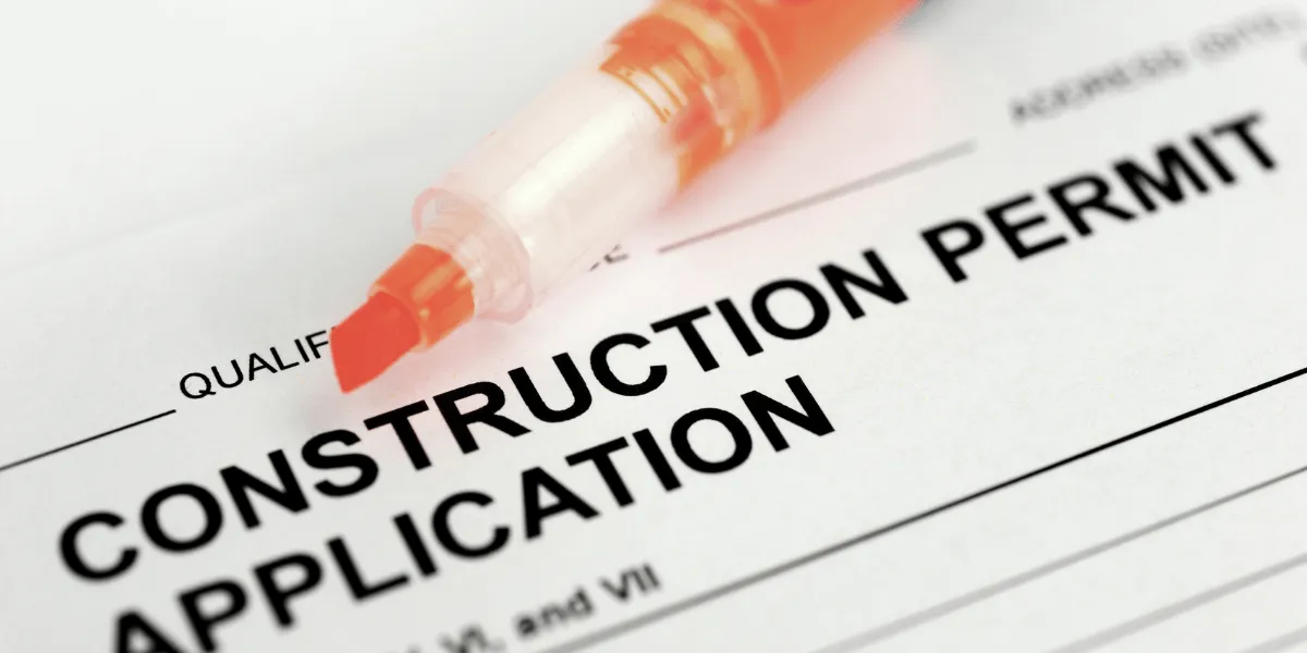 Close-up of a construction permit application form with a pen